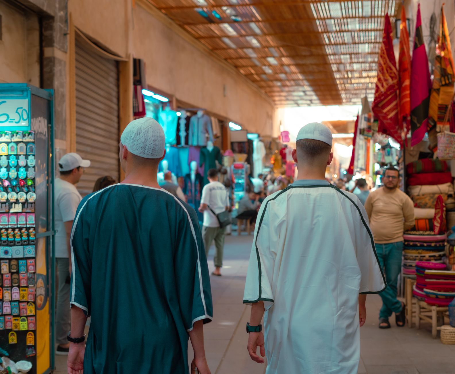 Vibrant street market in Marrakesh, capturing local culture and traditional attire.