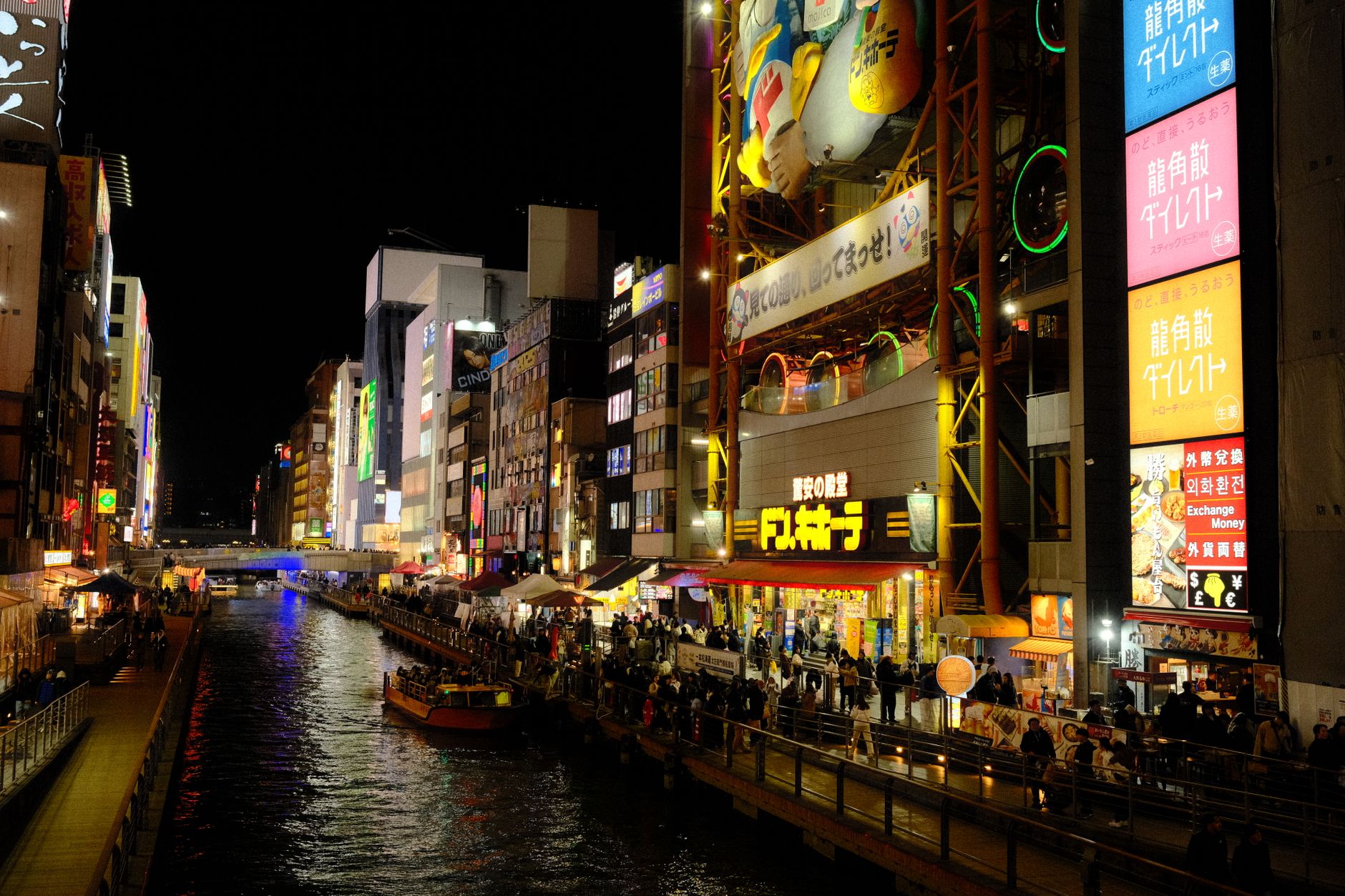 Explore the lively Dotonbori district in Osaka with its vibrant lights and bustling nightlife scene.